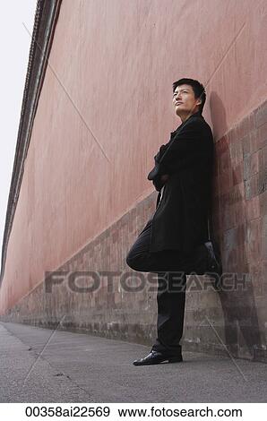 A man leans against a wall View Large Photo Image Stock Photo - A man leans against a wall. Fotosearch
