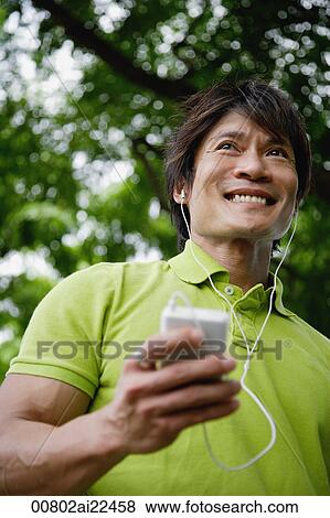 A man listens to music with headphones View Large Photo Image Stock Photo - A man listens to music with headphones. Fotosearch