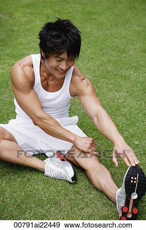 A man stretches in the park View Large Photo Image Stock Photo - A man stretches in the park. Fotosearch