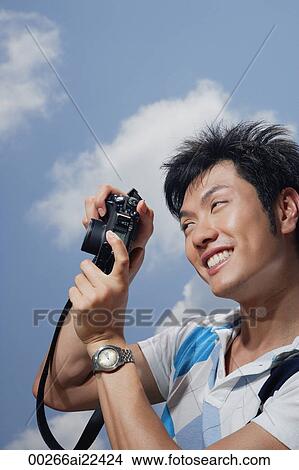 A man takes photos View Large Photo Image Picture - A man takes photos. Fotosearch