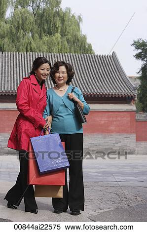A mother and adult daughter go shopping together View Large Photo Image Stock Photography - A mother and adult daughter go shopping together. Fotosearch