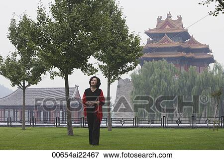 A woman stands in front of The Forbidden City, Beijing View Large Photo Image Stock Photo - A woman stands in front of The Forbidden City, Beijing. Fotosearch