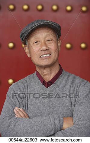 An old man crosses his arms and looks at the camera View Large Photo Image Stock Image - An old man crosses his arms and looks at the camera. Fotosearch