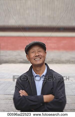 An old man crosses his arms and smiles at the camera View Large Photo Image Stock Image - An old man crosses his arms and smiles at the camera. Fotosearch