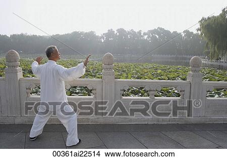 Picture - An old man practices Chinese martial arts. Fotosearch