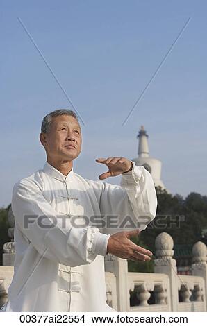 Picture - An old man practices Chinese martial arts. Fotosearch