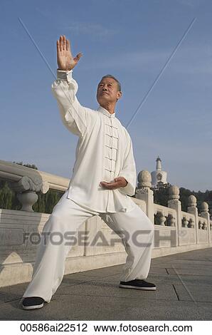 Stock Image - An old man practices Chinese martial arts. Fotosearch