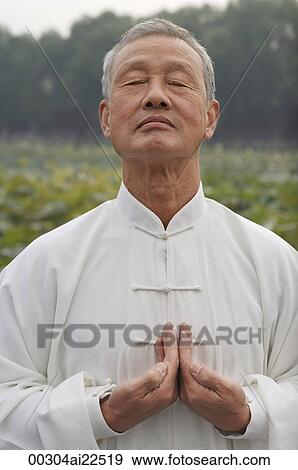 Stock Photo - An old man practices Chinese martial arts. Fotosearch