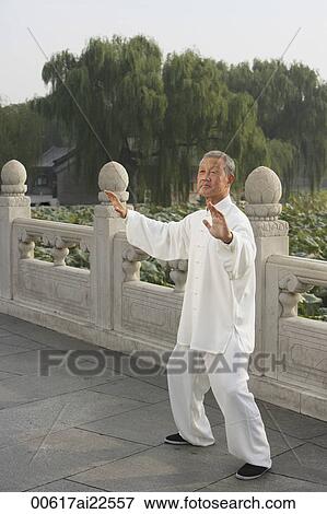 Stock Photo - An old man practices Chinese martial arts. Fotosearch