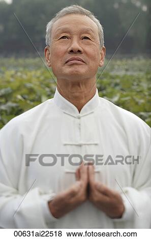 Stock Photo - An old man practices Chinese martial arts. Fotosearch
