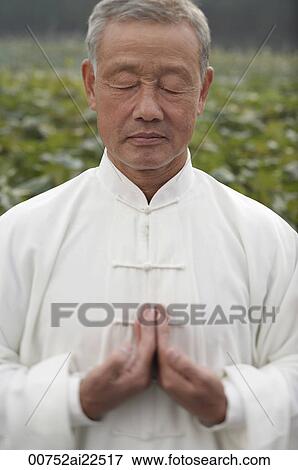 Stock Photo - An old man practices Chinese martial arts. Fotosearch