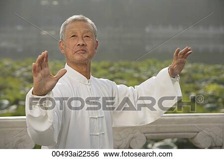 Stock Photograph - An old man practices Chinese martial arts. Fotosearch