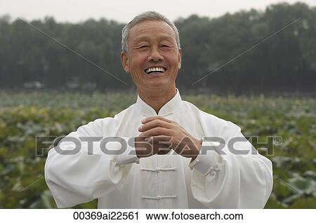 Stock Image - An old man smiles as he looks at the camera. Fotosearch
