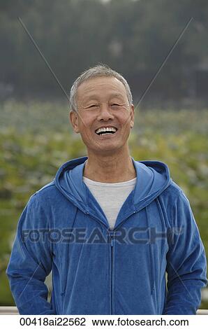 Stock Image - An old man smiles as he looks at the camera. Fotosearch