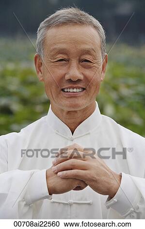 Stock Image - An old man smiles as he looks at the camera. Fotosearch