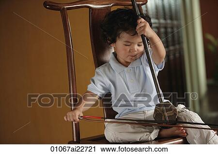 Baby boy playing a musical instrument View Large Photo Image Stock Image - Baby boy playing a musical instrument. Fotosearch