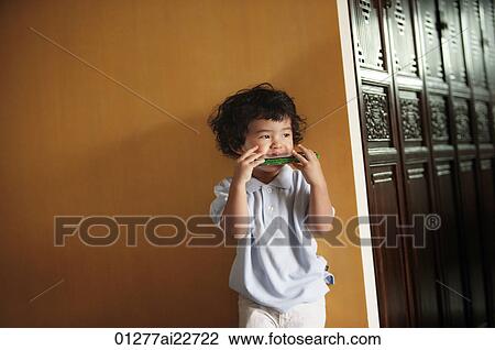 Baby boy playing harmonica View Large Photo Image Stock Image - Baby boy playing harmonica. Fotosearch