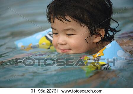 Baby boy swimming in pool View Large Photo Image Stock Image - Baby boy swimming in pool. Fotosearch