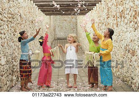 Stock Image - Balinese girls and European girl. Fotosearch