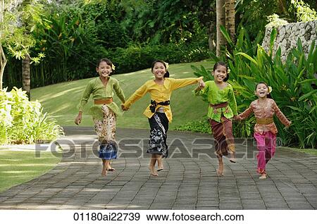 Stock Photo - Balinese girls laughing and running. Fotosearch