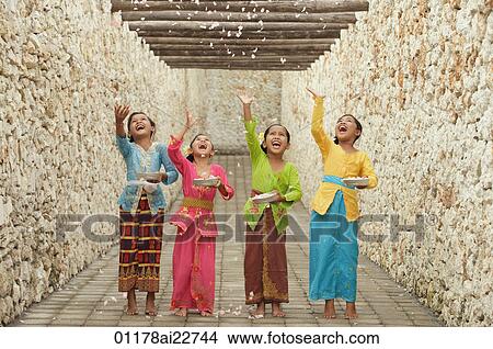Balinese girls throwing flowers View Large Photo Image Picture - Balinese girls throwing flowers. Fotosearch