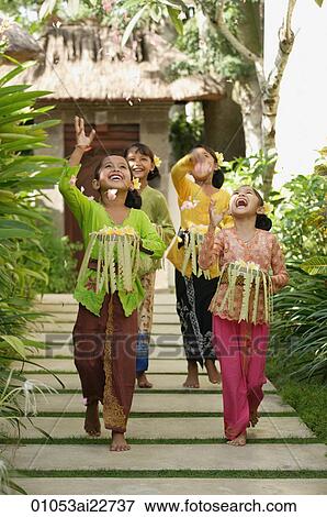 Balinese girls throwing flowers View Large Photo Image Stock Photo - Balinese girls throwing flowers. Fotosearch