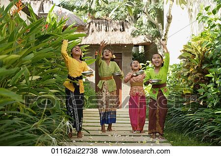 Stock Photo - Balinese girls throwing flowers. Fotosearch