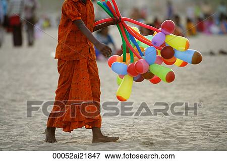 Stock Photo - Balloon vendor on beach, Mumbai, India. Fotosearch