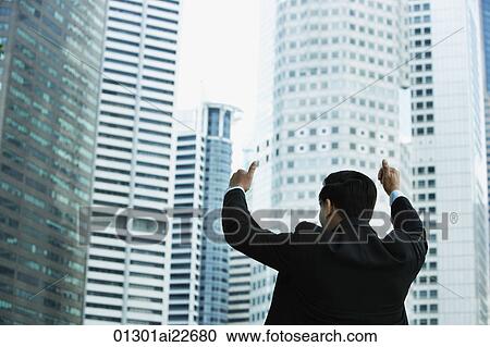 Businessman gives thumbs up, in front of skyscrapers View Large Photo Image Stock Image - Businessman gives thumbs up, in front of skyscrapers. Fotosearch