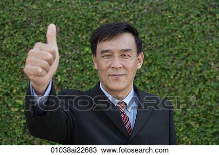 Stock Image - Businessman giving his thumb up. Fotosearch
