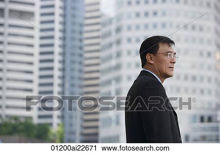 Stock Image - Businessman in the city. Fotosearch