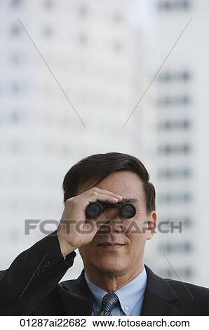 Businessman looking though binoculars View Large Photo Image Stock Image - Businessman looking though binoculars. Fotosearch