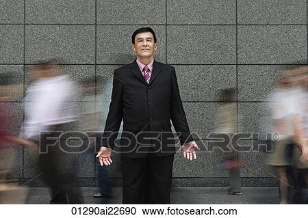 Businessman standing in crowd View Large Photo Image Stock Image - Businessman standing in crowd. Fotosearch