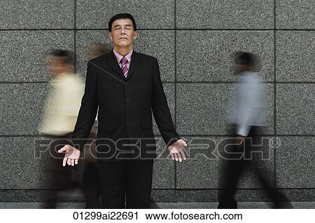 Businessman standing in crowd View Large Photo Image Stock Image - Businessman standing in crowd. Fotosearch