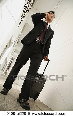 Businessman talking on mobile phone View Large Photo Image Stock Image - Businessman talking on mobile phone. Fotosearch