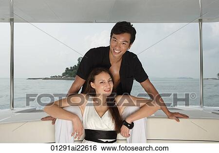 Couple on yacht, smiling at camera View Large Photo Image Stock Photograph - Couple on yacht, smiling at camera. Fotosearch
