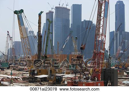 Stock Photo - Cranes at construction site in front of cityscape. Fotosearch