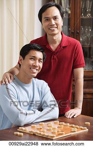 Father and son playing board game View Large Photo Image Stock Photo - Father and son playing board game. Fotosearch