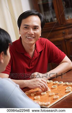 Father and son playing board game View Large Photo Image Stock Photograph - Father and son playing board game. Fotosearch