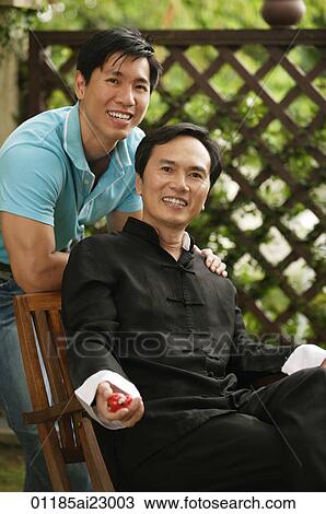 Father and son smiling at camera View Large Photo Image Stock Image - Father and son smiling at camera. Fotosearch