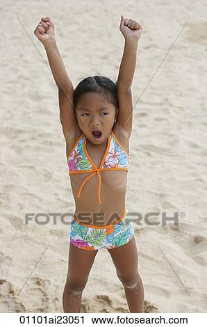 Stock Image - Girl raising arms and shouting. Fotosearch
