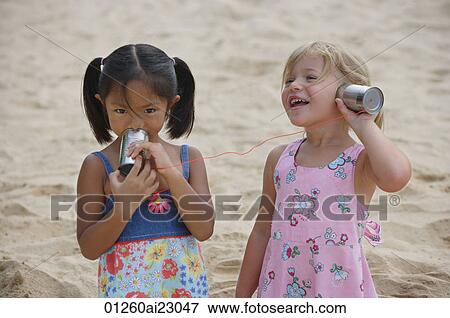 Girls playing with toy phones View Large Photo Image Stock Photo - Girls playing with toy phones. Fotosearch