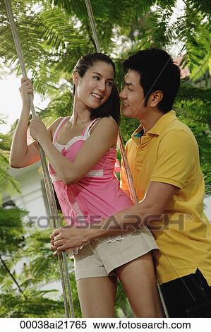 Man and woman in park, looking at each other View Large Photo Image Stock Photography - Man and woman in park, looking at each other. Fotosearch