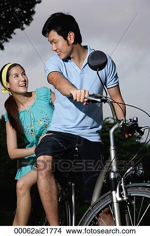 Picture - Man and woman on tandem bike. Fotosearch