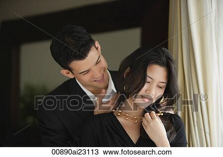 Stock Image - Man caressing woman's neck. Fotosearch