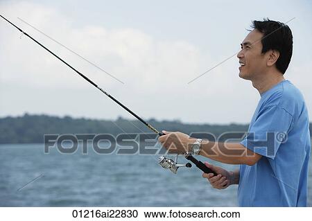 Stock Image - Man fishing in the sea. Fotosearch