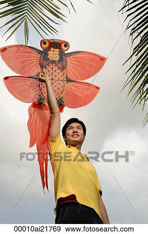 Stock Photo - Man flying kite. Fotosearch