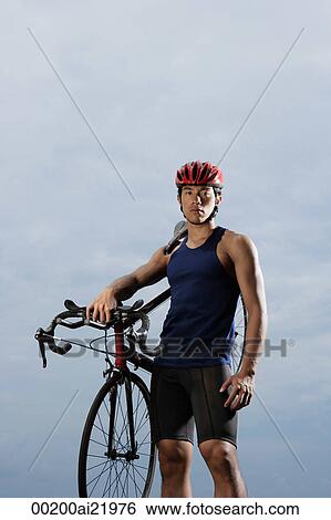 Man holding bike over shoulder, looking at camera, wearing helmet View Large Photo Image Stock Photograph - Man holding bike over shoulder, looking at camera, wearing helmet. Fotosearch