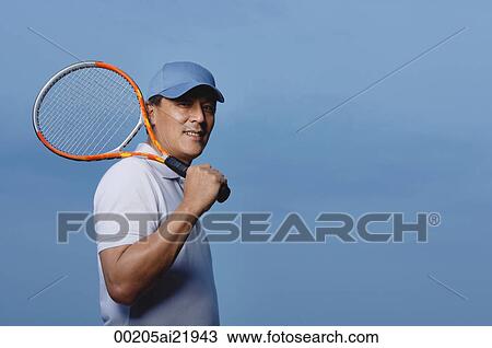 Man holding tennis racket, playing sports View Large Photo Image Stock Image - Man holding tennis racket, playing sports. Fotosearch
