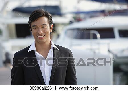 Man in front of yacht, smiling at camera View Large Photo Image Stock Image - Man in front of yacht, smiling at camera. Fotosearch